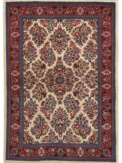 Tappeto persiano Saruq, con motivi floreali a tutto campo rosa e blu su sfondo bianco, con spessa cornice rossa decorata a motivi floreali.